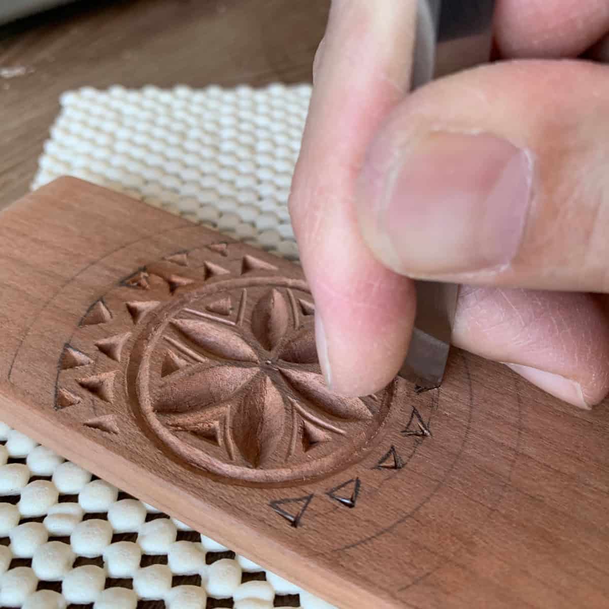 Carving a practice Daghdaghan in cherry.
